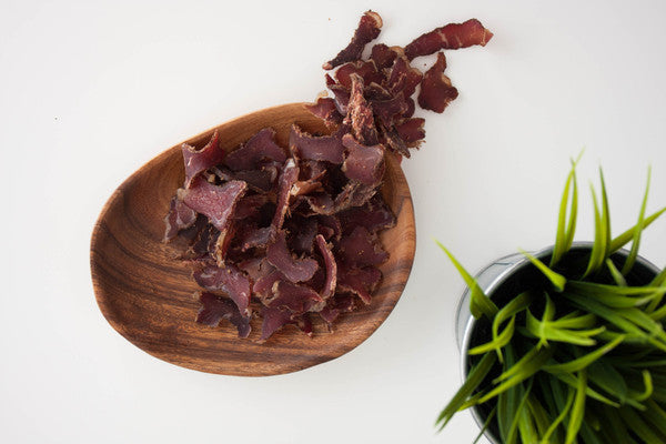 Grass fed biltong on white table